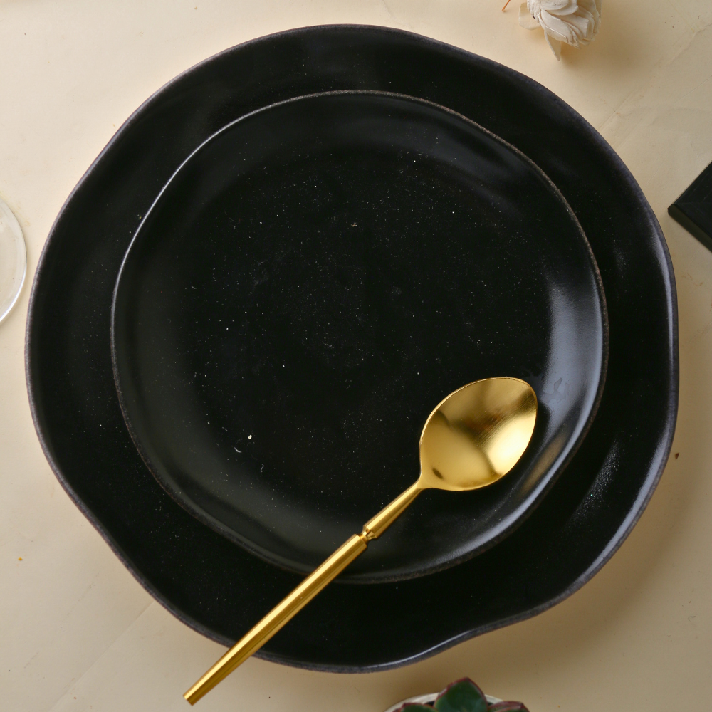 Brass Golden tea spoon in plate
