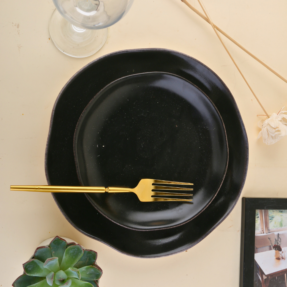 Golden fork on black plate