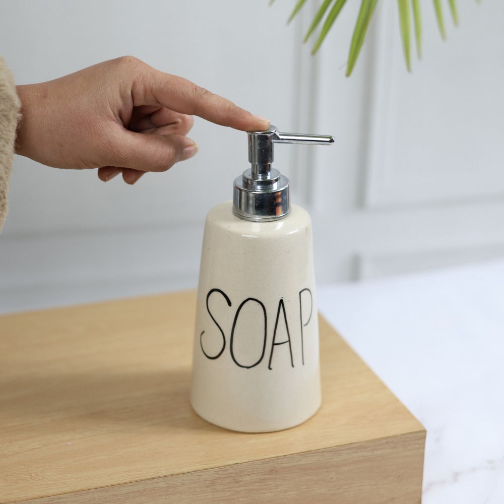 Handmade ceramic soap dispenser in hand