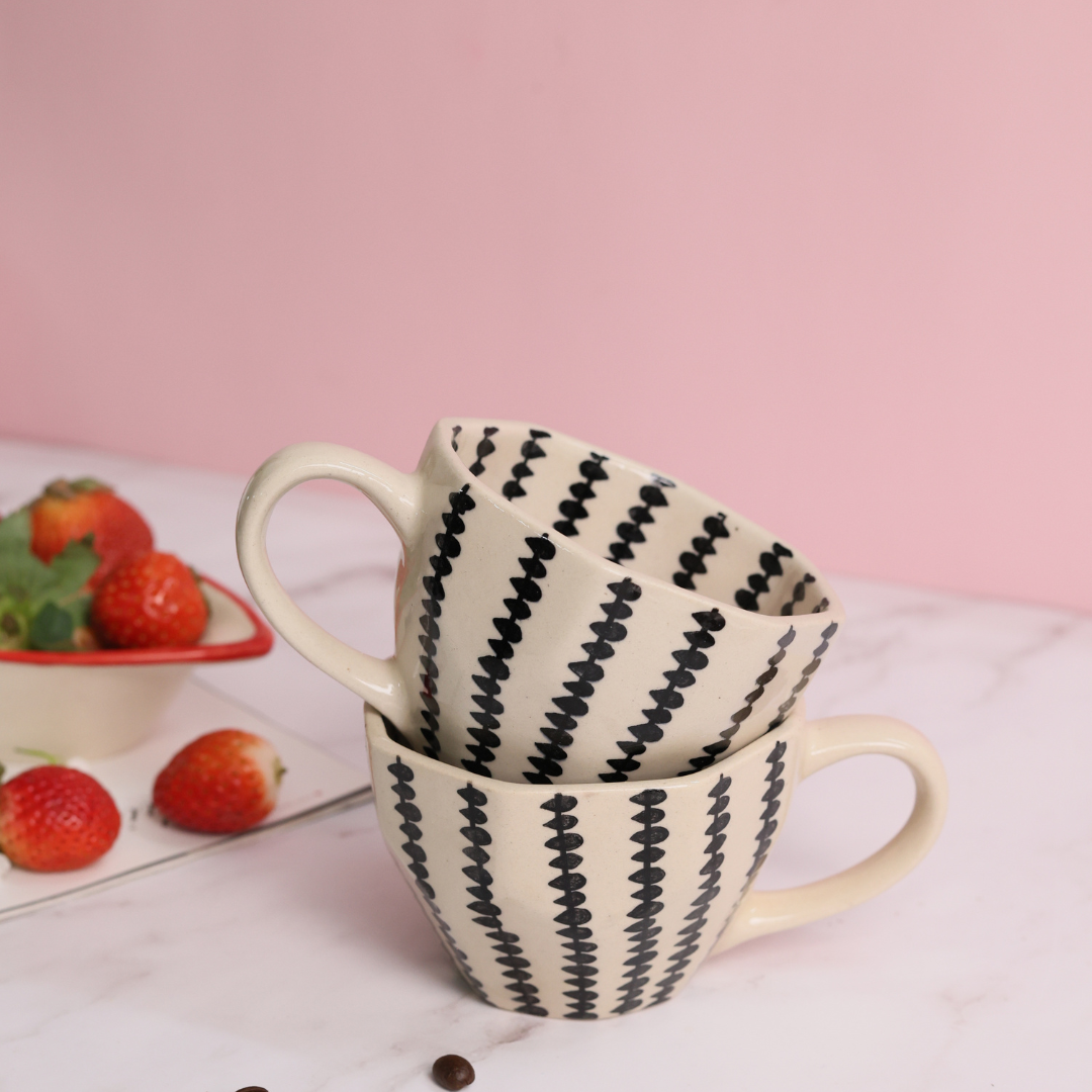 Black crosses coffee mug on each other with strawberries