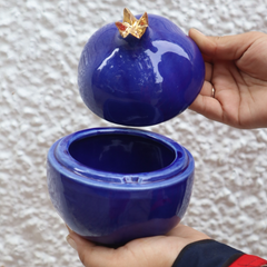 Anar jar royal blue with open lid in a hand