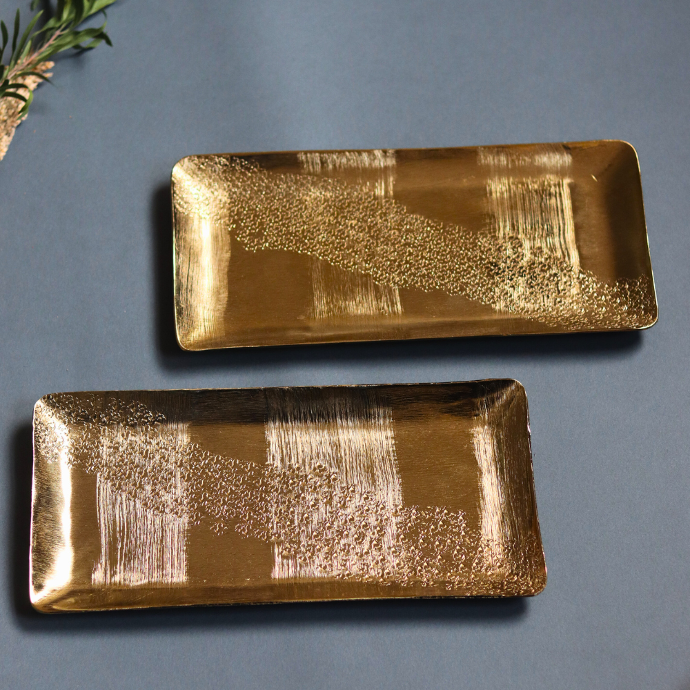 Two golden hammered serveware platters