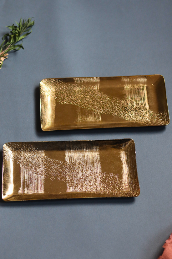 Two golden hammered serveware platters
