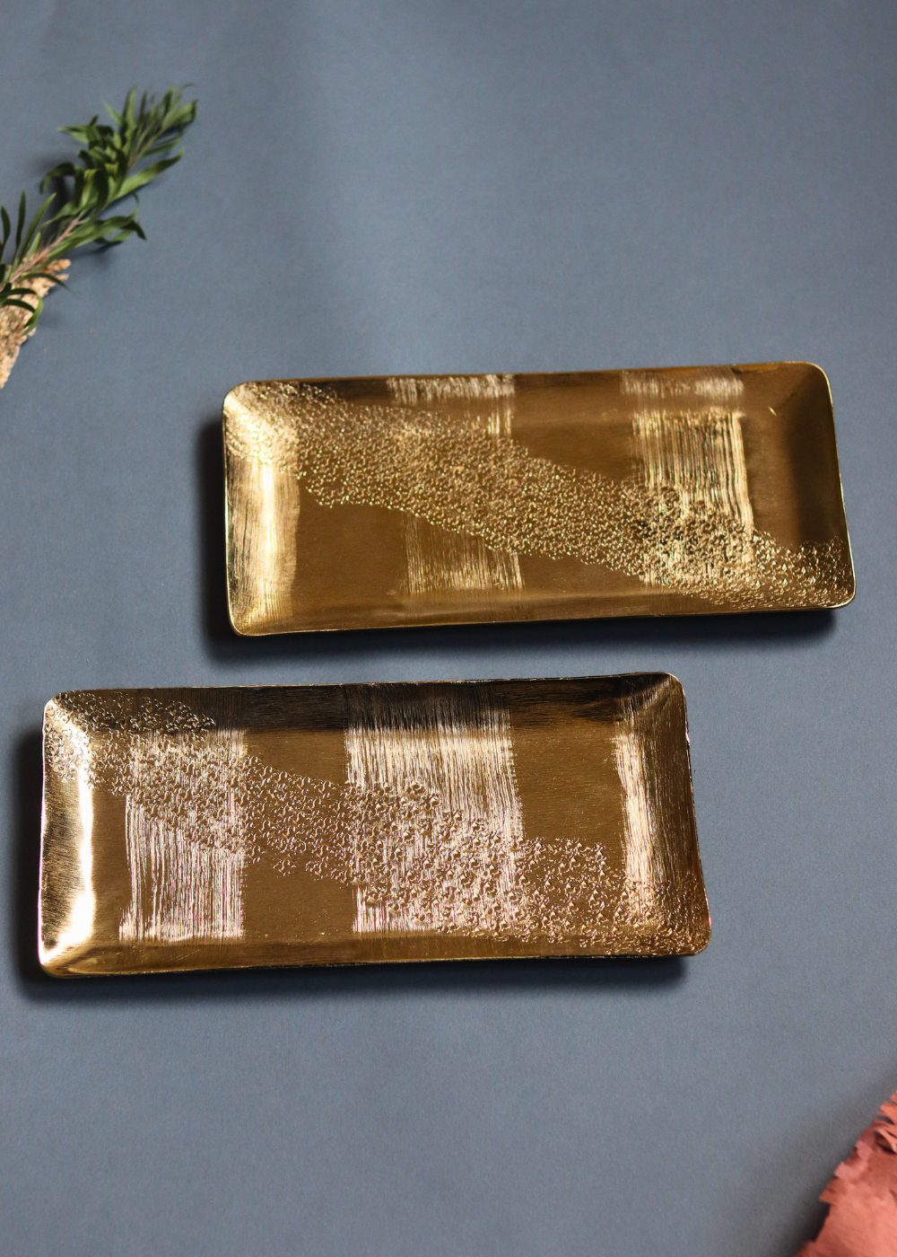 Two golden hammered serveware platters