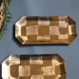 Two square patterned gold platters