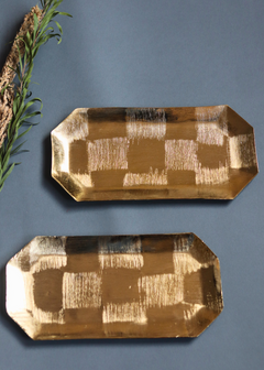 Two square patterned gold platters