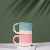 two handmoulded mugs pink & teal color