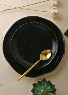 Brass Golden tea spoon in plate