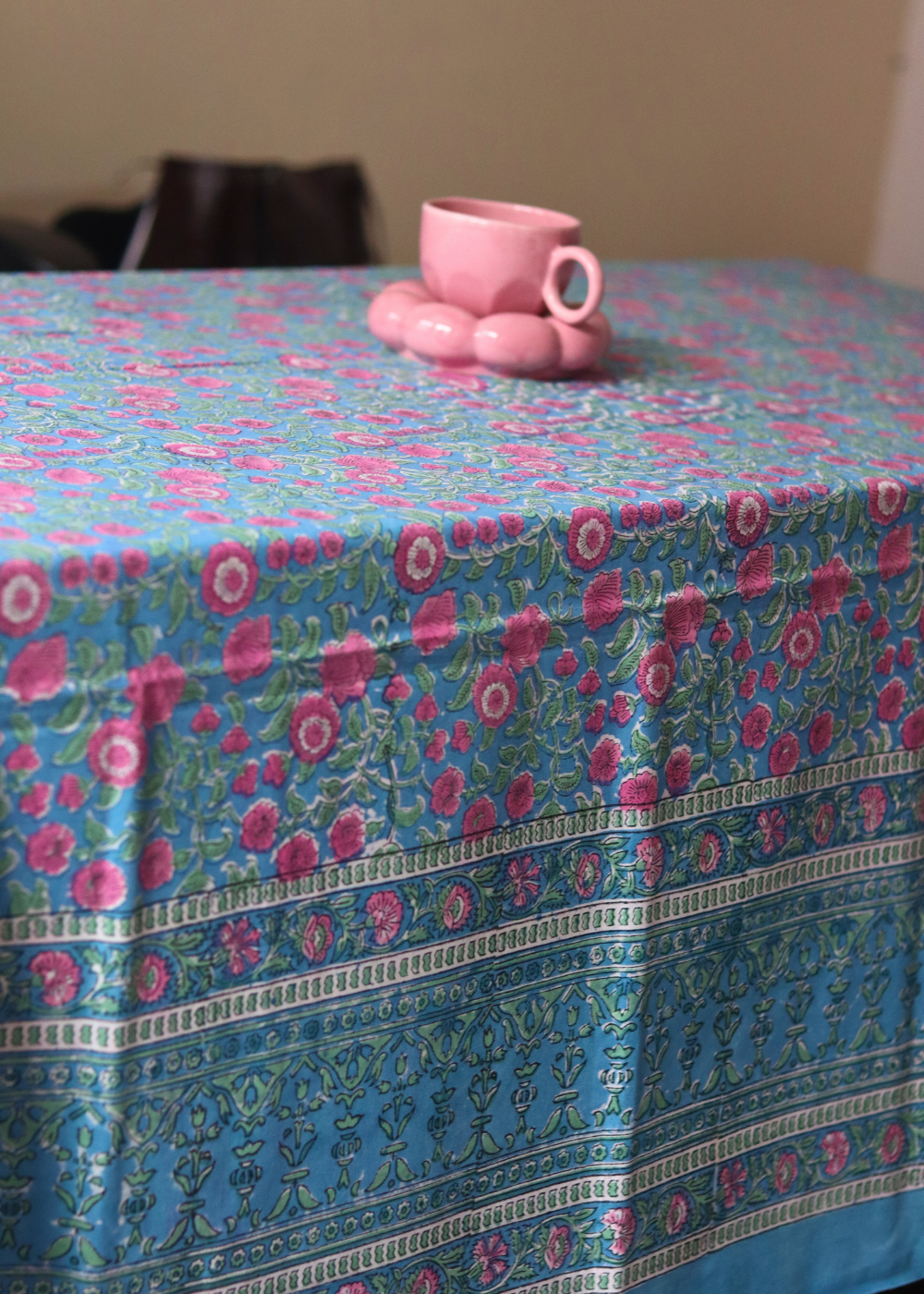 Handmade table cloth with cup & saucer on it