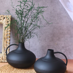 Two black handmade flower pots with plant