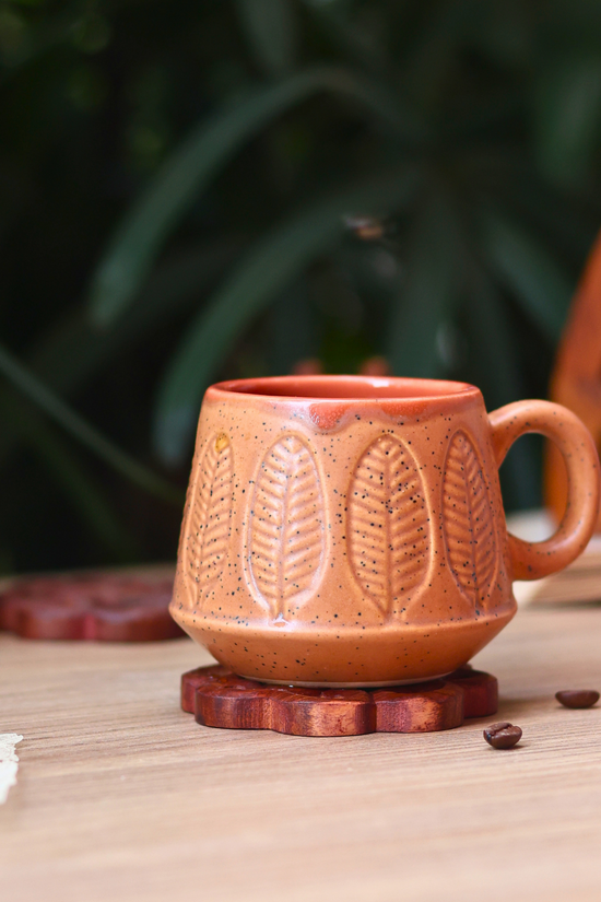Brown serene leaf coffee mug on wooden lid