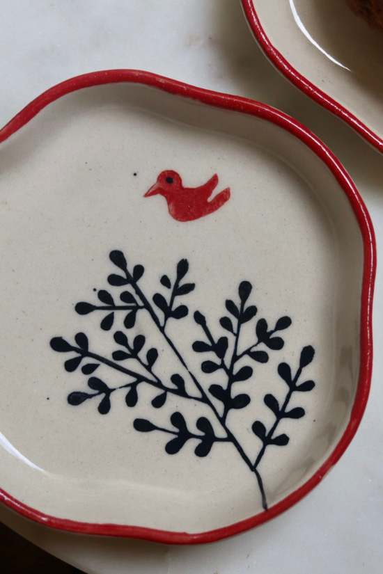 Red sparrow flying on dessert plate