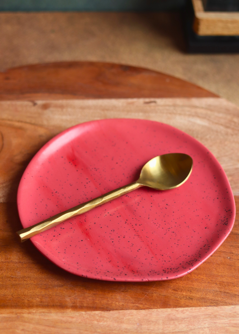 handmade red snacks plate with golden spoon