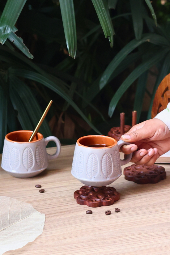 Ceramic coffee mug in hand 