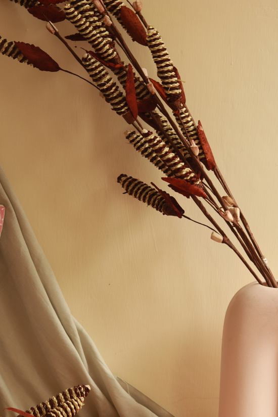 Dried pine chain flower bunch in vase