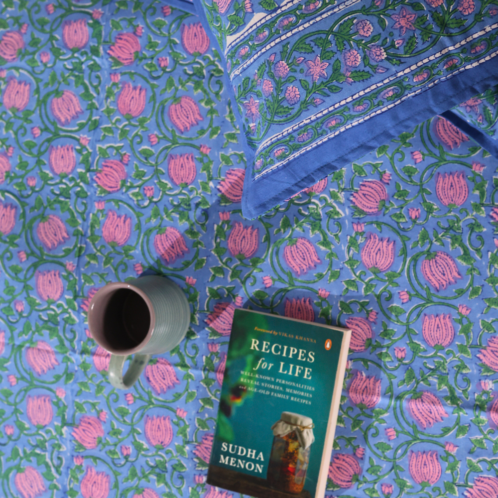 Blue pink lotus bedsheet with book and coffee