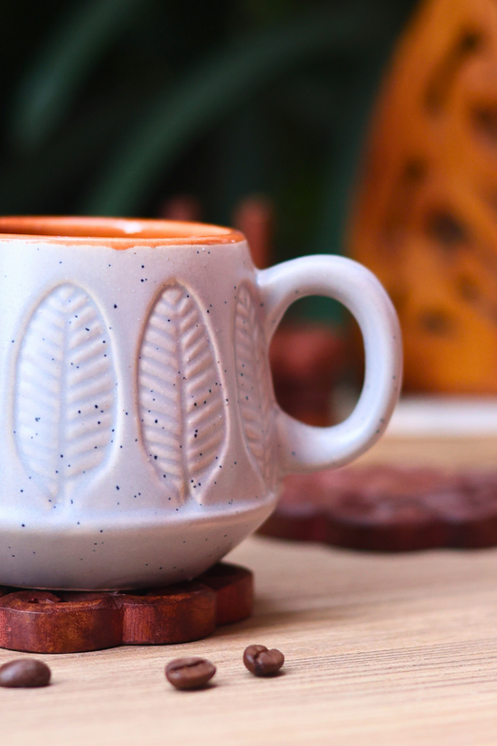 Closeup shot of grey serene leaf coffee mug