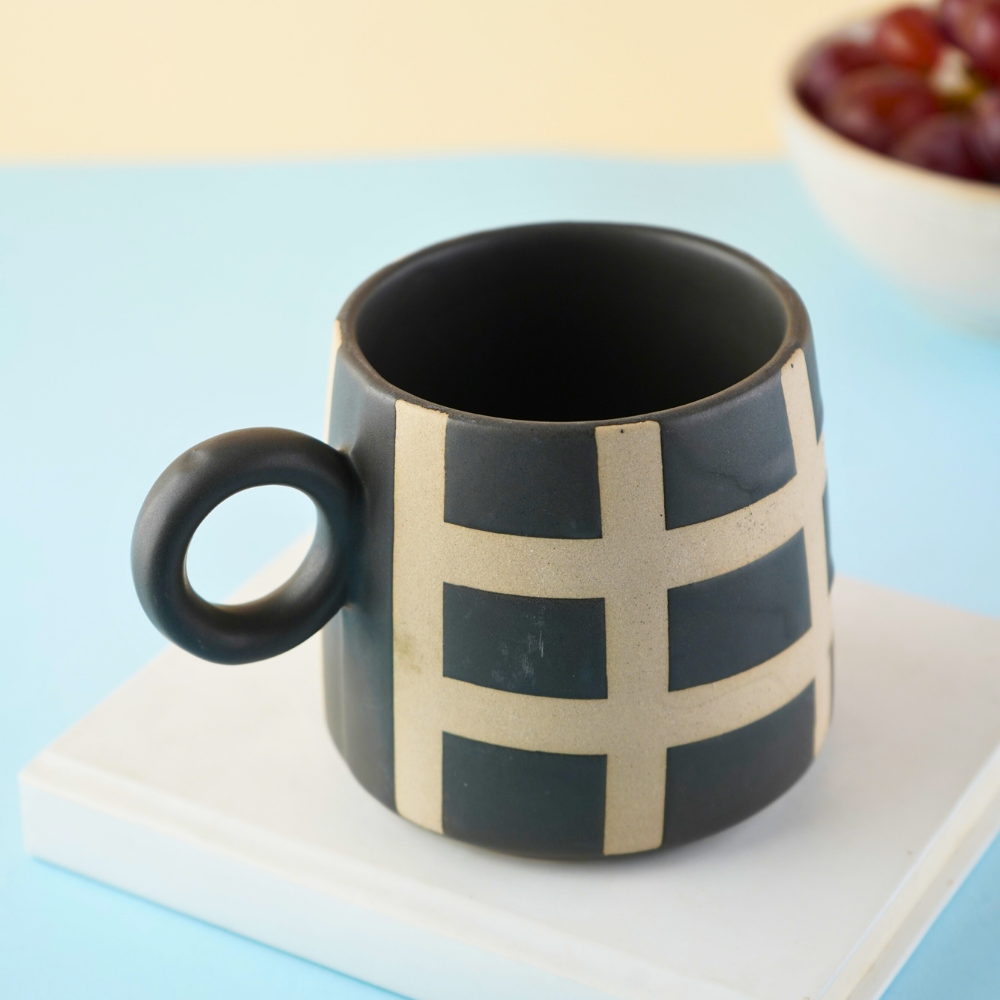 black checkered mug made by ceramic 
