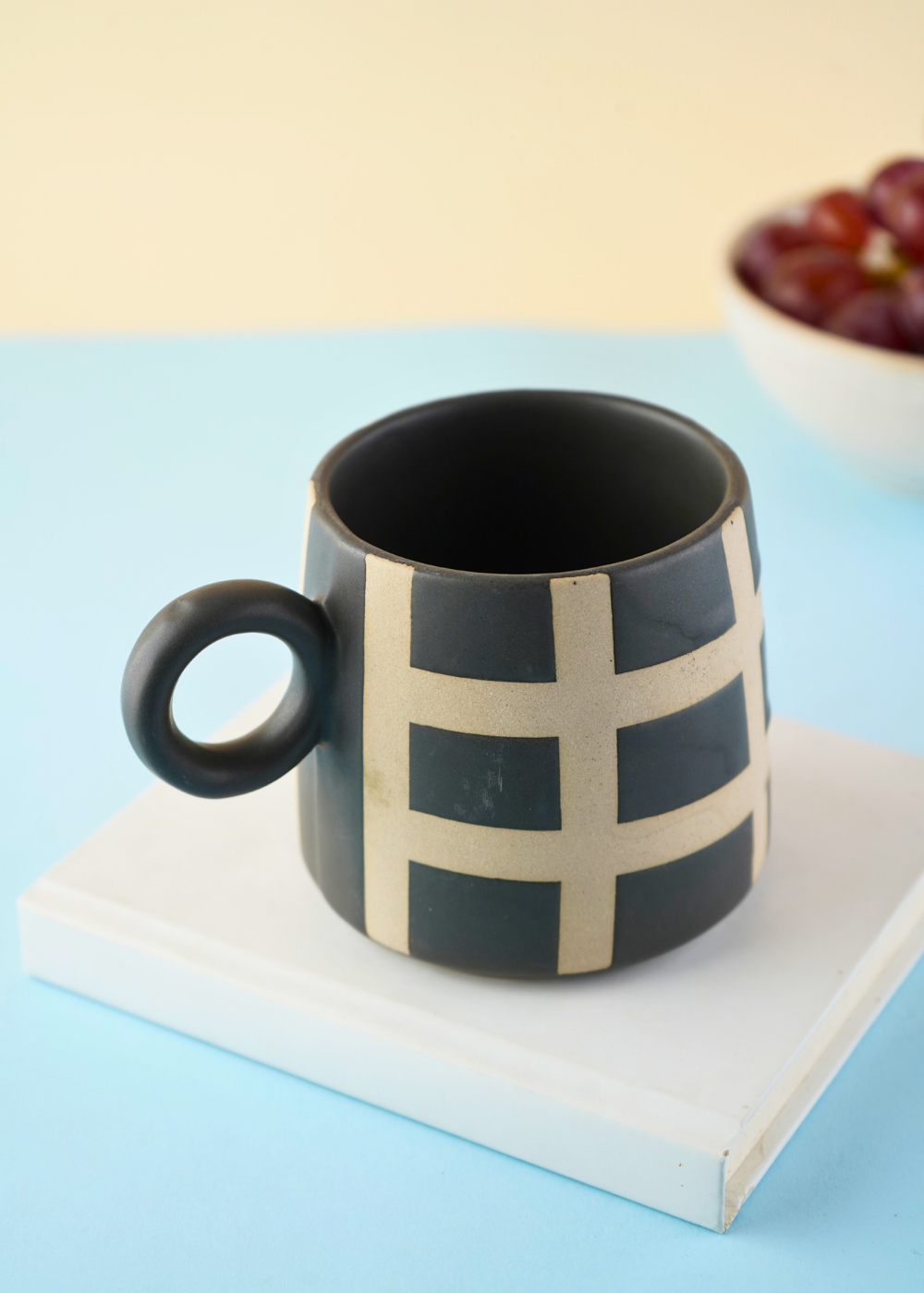 black checkered mug made by ceramic 