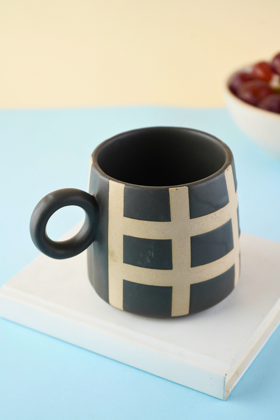 black checkered mug made by ceramic 