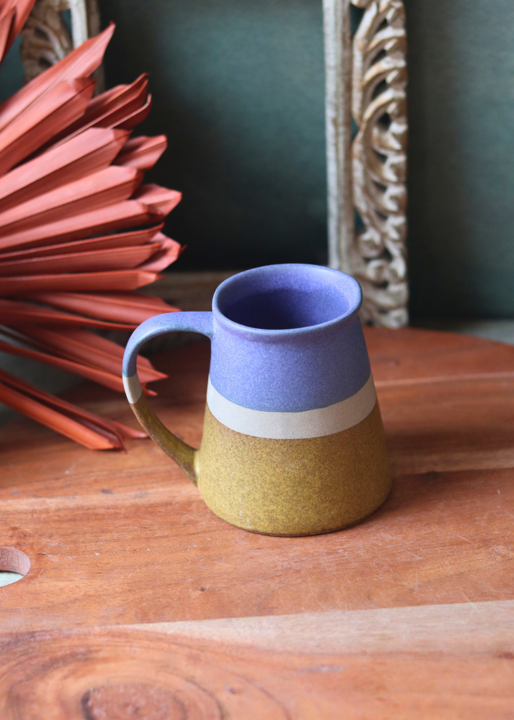 Blue & Mustard coffee mug on wooden surface