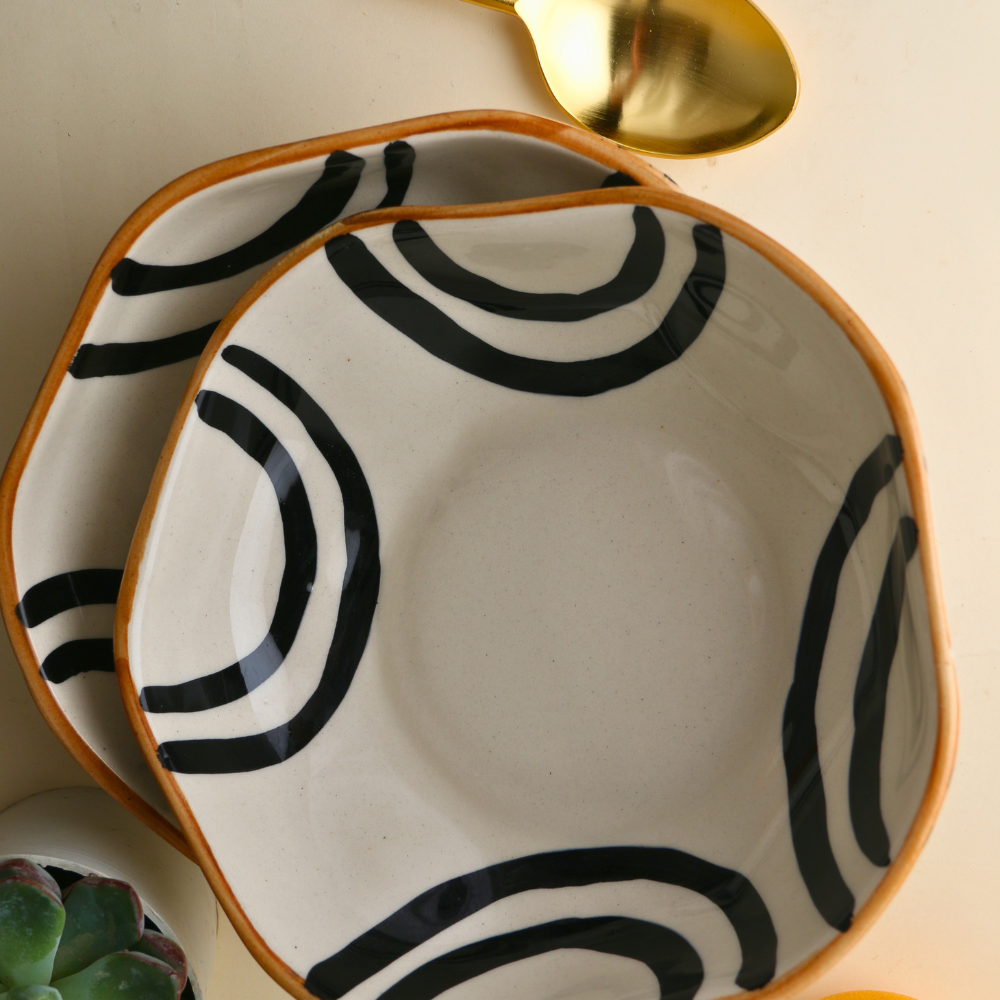  Two black and white bowl with cutleries and orange
