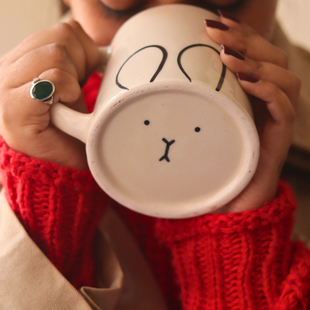 Handmade coffee mug in girls hand