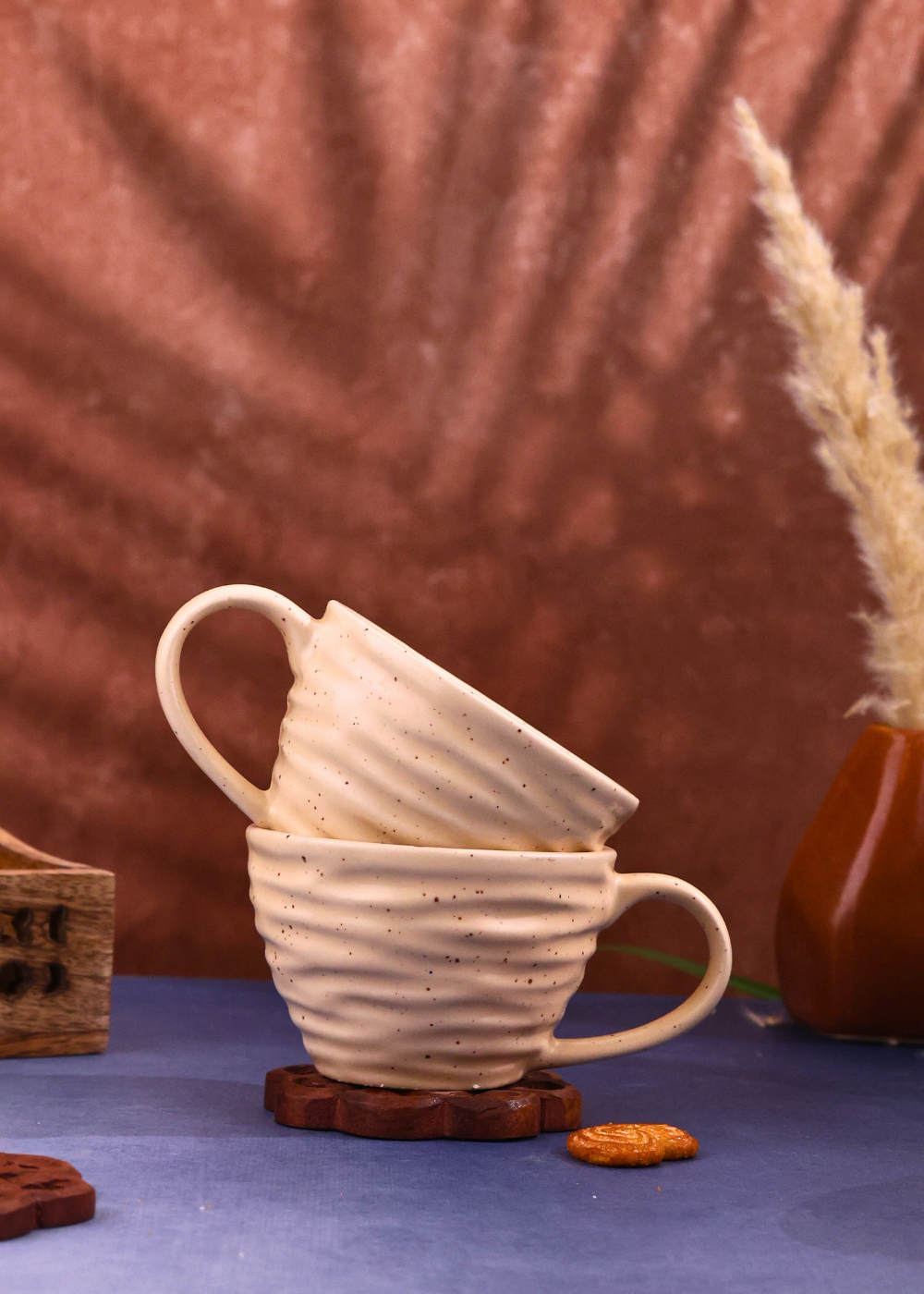 Two twirl coffee mugs on wooden surface