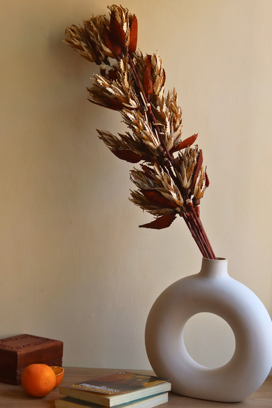Dried flowers in white vase 