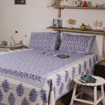 A systematic room with a beautiful block printed bedsheet