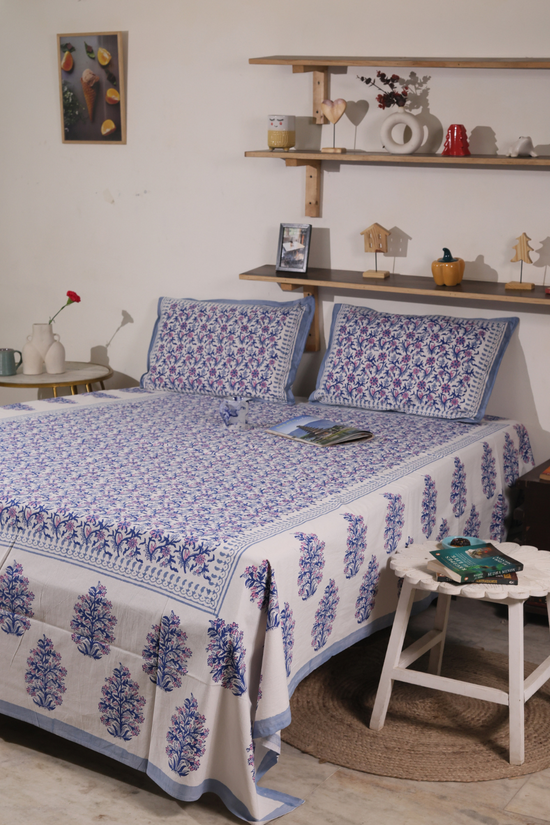 A systematic room with a beautiful block printed bedsheet