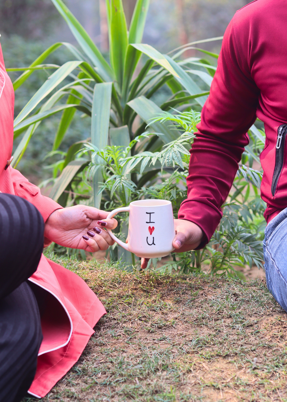 A couple holding a coffee mug quoted i heart you