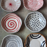 red & black bowls made by ceramic 
