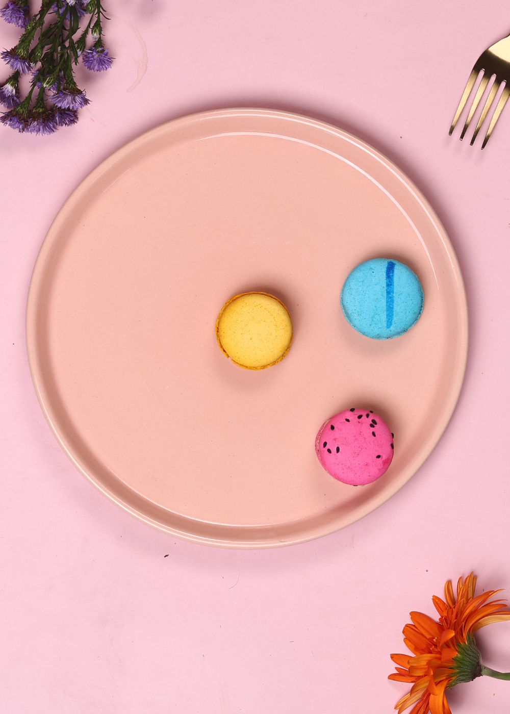 Pink platter having three colorful macarons