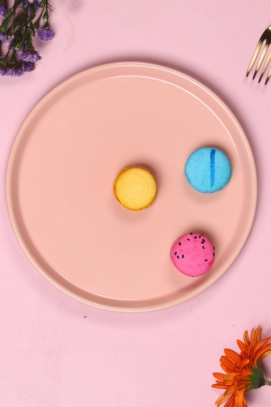 Pink platter having three colorful macarons
