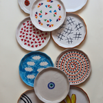 ten snack plates with different design & colors