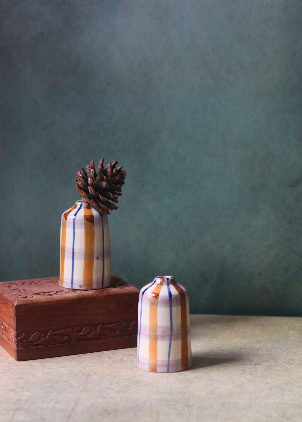 chequered bud vase tall on wood