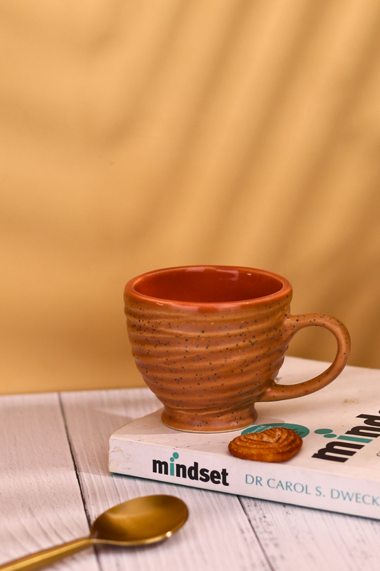 Brown torrent chai cups on book