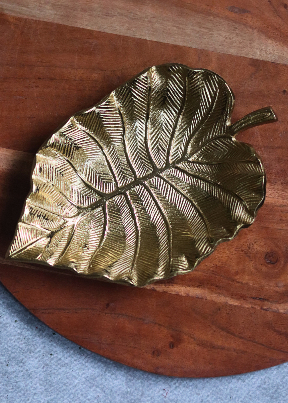 Handmade golden palm leaf bowl on wood