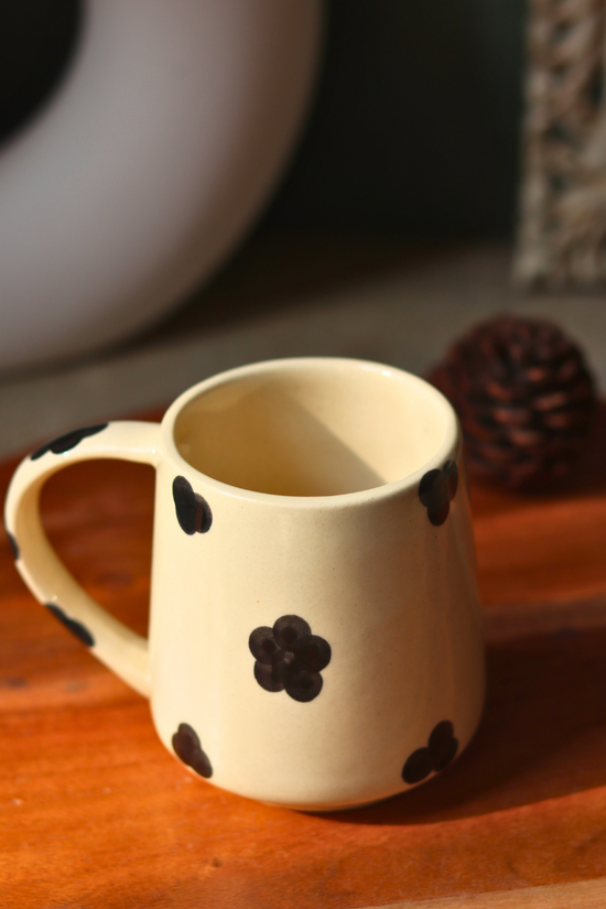 Handmade black & white mug with black flower design on it