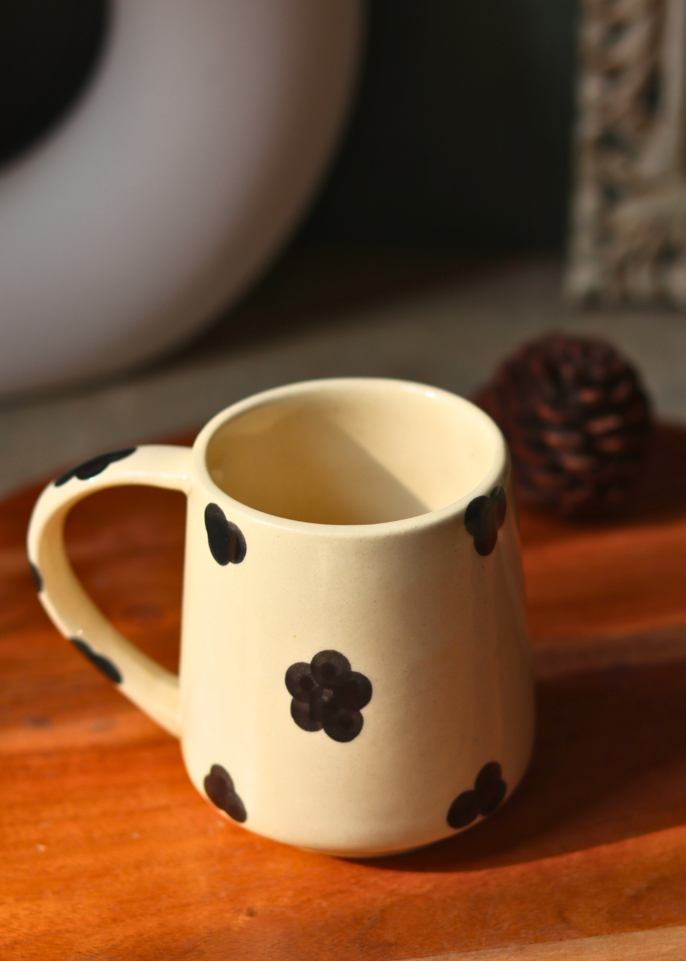Handmade black & white mug with black flower design on it