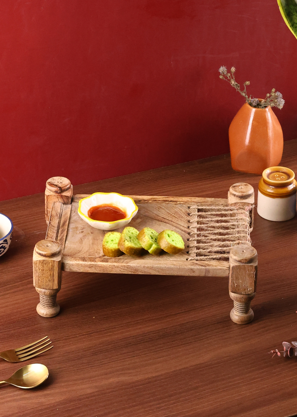 Wooden charpai serving tray with snacks 