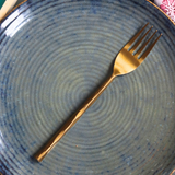 Handmade gold hammered fork on plate