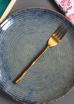 Handmade gold hammered fork on plate