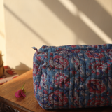 Block printed toiletry bag on a wooden surface