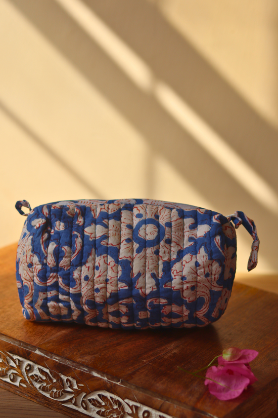 blue floral toiletry bag small size on wooden surface