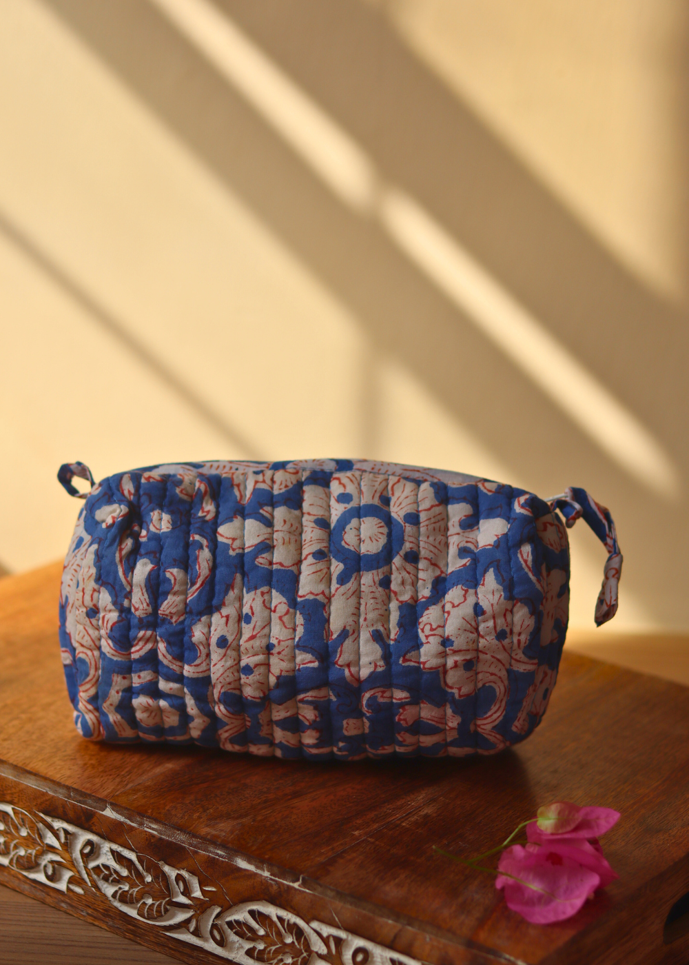 blue floral toiletry bag small size on wooden surface