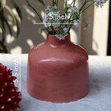 Ceramic pink round vase with flowers
