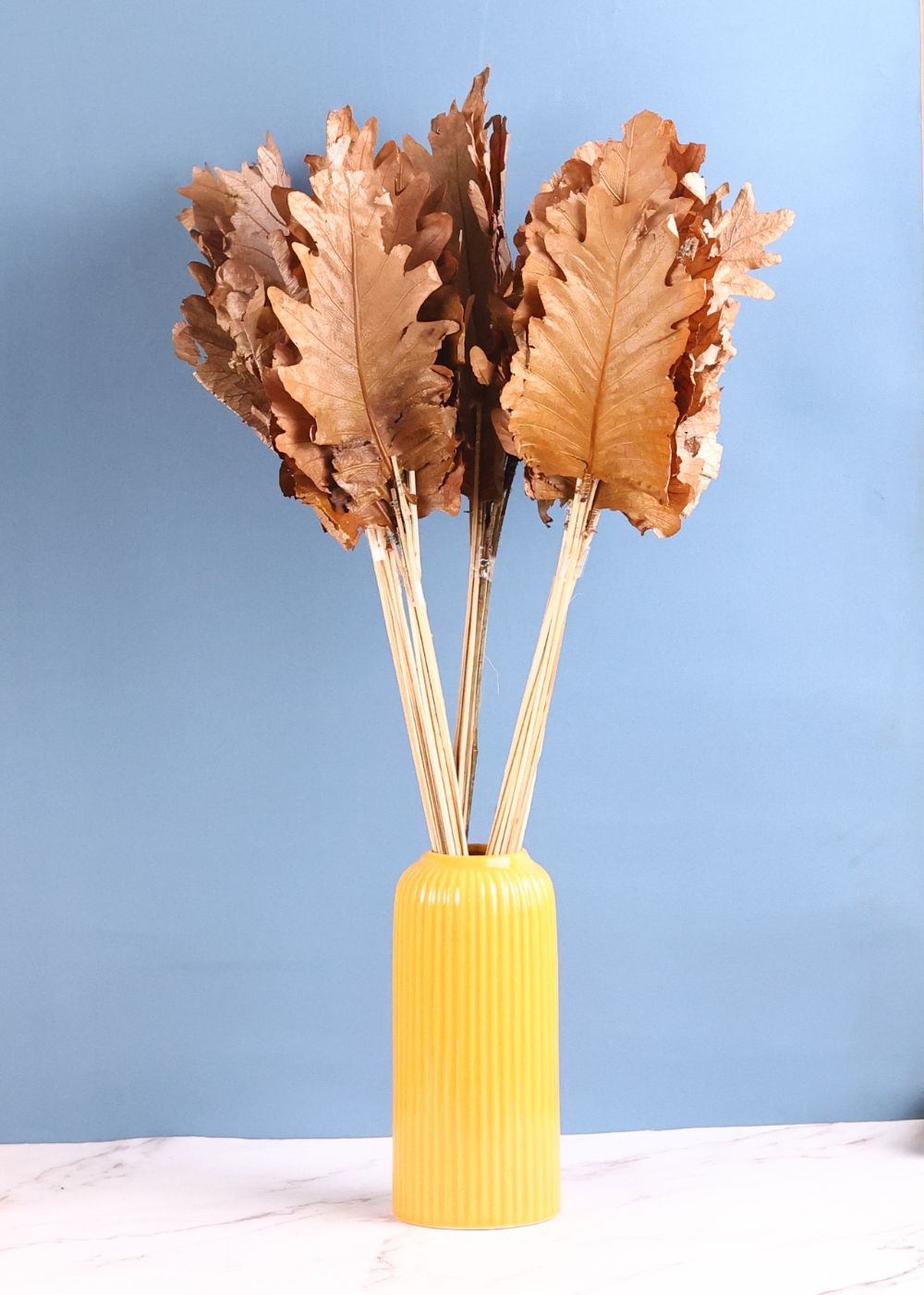 Dried natural leaf bunch with yellow vase