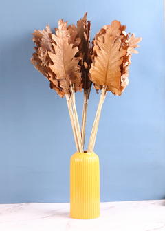 Dried natural leaf bunch with yellow vase